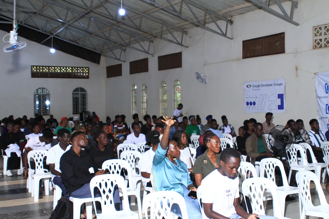 Attendees seated through a session in the main hall at DevFest Jinja 2025