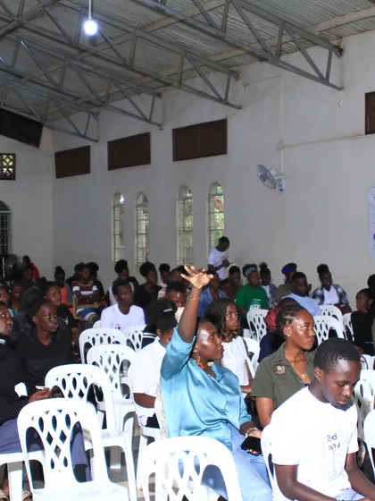 A full hall of attendees during a session at DevFest Jinja 2025