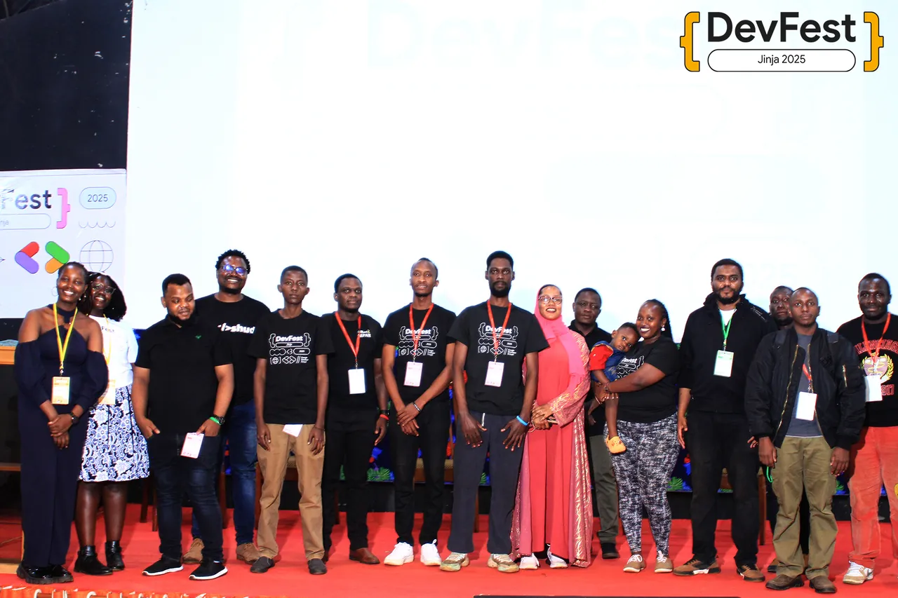 Organizers and volunteers on the main stage at DevFest Jinja 2025